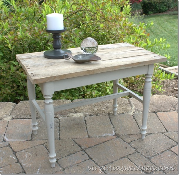 A vanity bench becomes a side table with paint and the addition of a pallet wood top.  virginiasweetpea.com