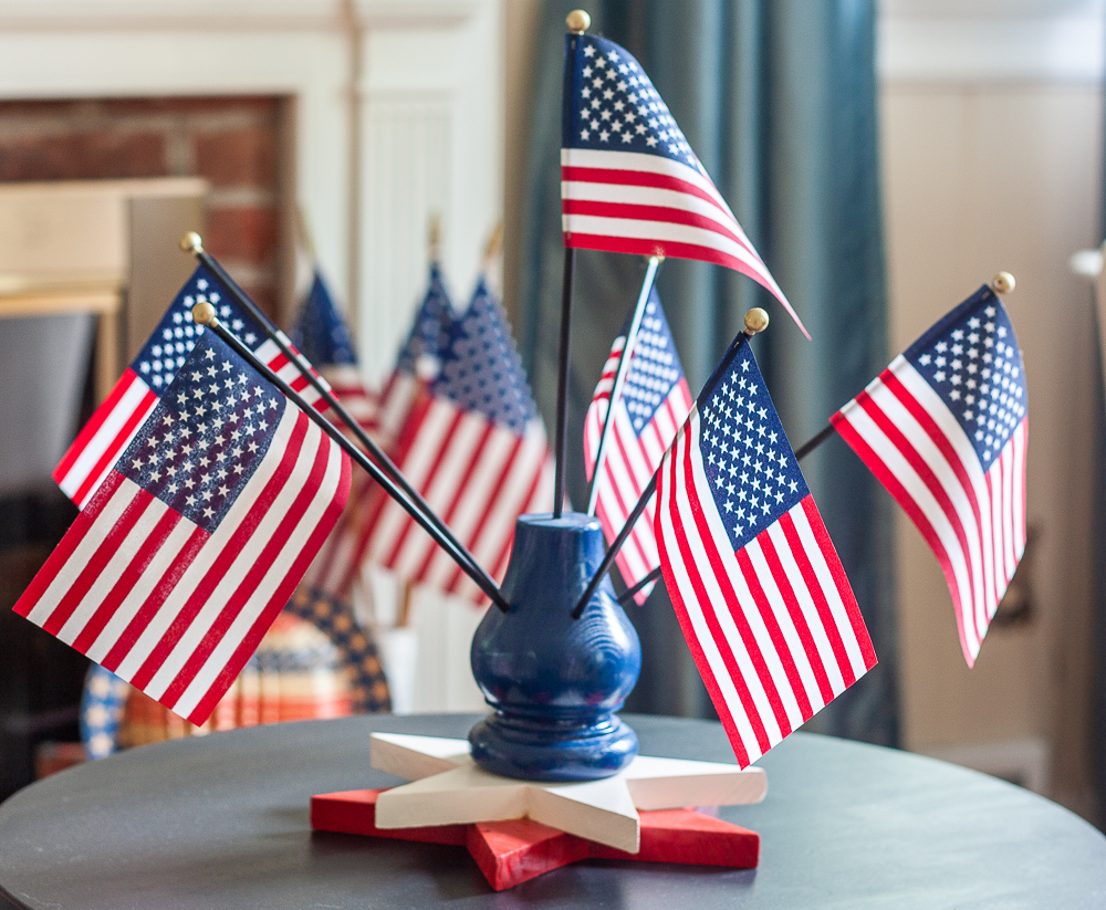 Flag Display holding six American flags with a two wooden star base.