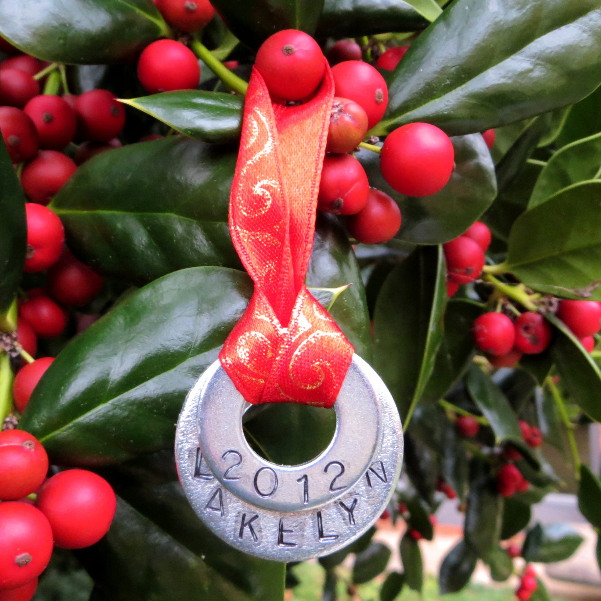 Christmas ornament made with stamped metal washers layered together.