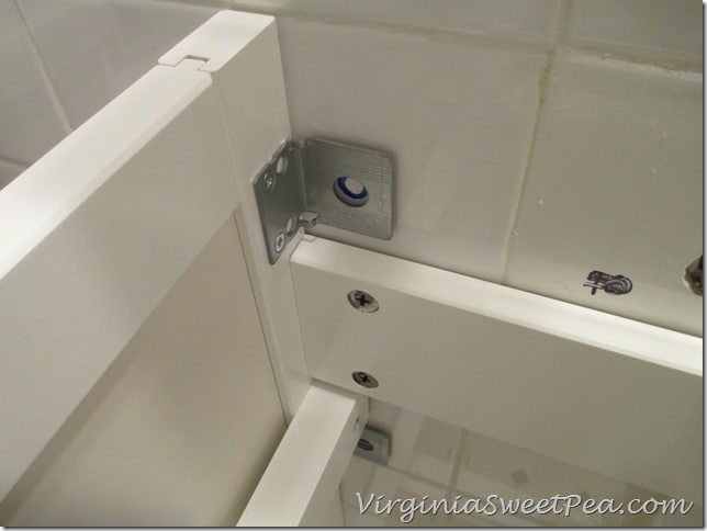 Attaching a bathroom cabinet to the wall 