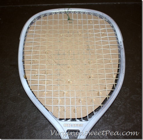  Poinsettia Wreath made using an upcycled Racketball Racket - Get the step-by-step tutorial to make your own Christmas wreath using an old racketball racket.