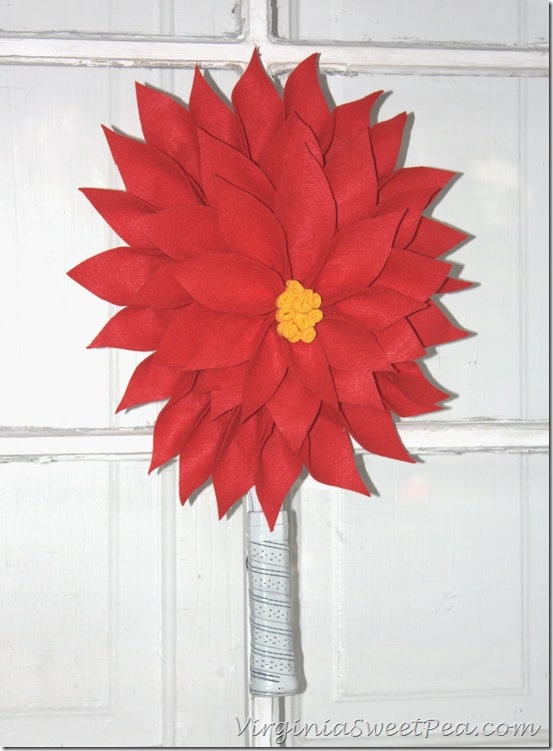  Poinsettia Wreath made using an upcycled Racketball Racket - Get the step-by-step tutorial to make your own Christmas wreath using an old racketball racket.