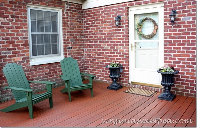 Refresh your deck for summer with stain, paint, and urns filled with flowers.