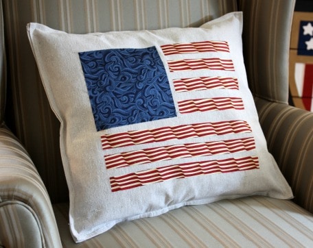 Patriotic pillow made from a drop cloth and quilting fabric. The fabric pieces were cut and ironed on with stitch witchery. This is a quick and easy DIY. virginiasweetpea.com