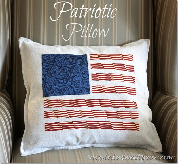 Patriotic pillow made from a drop cloth and quilting fabric.  The fabric pieces were cut and ironed on with stitch witchery.  This is a quick and easy DIY.  virginiasweetpea.com