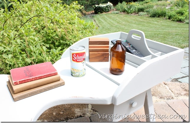 Antique books displayed with a vintage Schmidt Beer can on a cobbler's bench coffee table made over with paint.  virginiasweetpea.com