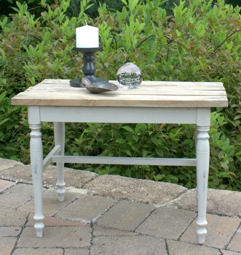 A vanity bench becomes a side table with paint and the addition of a pallet wood top. virginiasweetpea.com