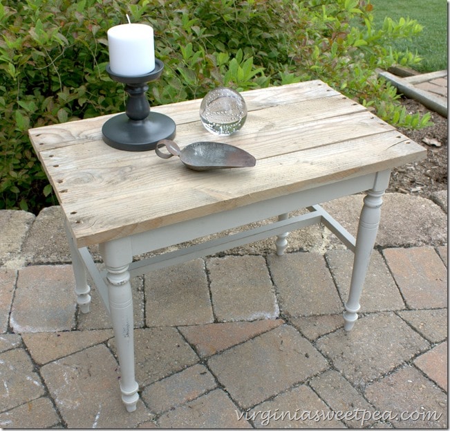 A vanity bench becomes a side table with paint and the addition of a pallet wood top. virginiasweetpea.com