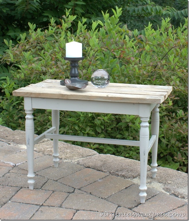 A vanity bench becomes a side table with paint and the addition of a pallet wood top. virginiasweetpea.com