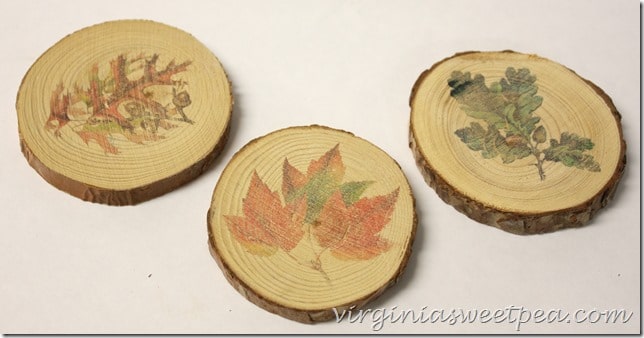 Coasters made from wood slices with fall images.