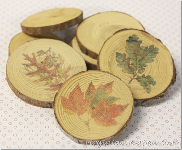 Coasters made from wood slices with fall images.