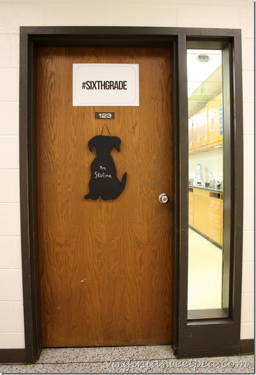 A wooden cut-out sign in the shape of a dog makes a welcoming entrance to this teacher's classroom. virginiasweetpea.com