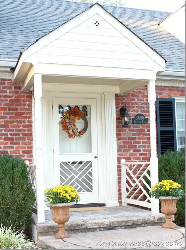 A fall porch with mums and a pretty wreath is a great way to greet guests. virginiasweetpea.com