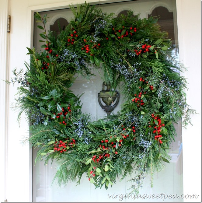 Handmade Christmas Wreath Using Fresh Greenery - Holly and Cedar Berries accent the texture of the greenery used.