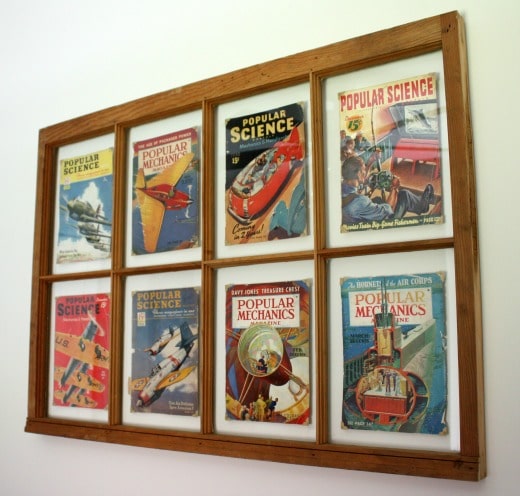 A vintage window is used as a frame for magazine covers