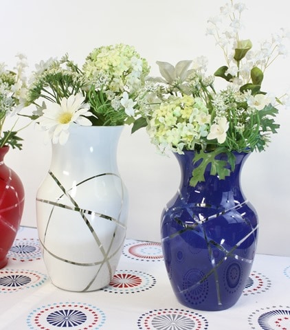 Learn how to make DIY patriotic vases with thrift store vases, rubber band, and spray paint.