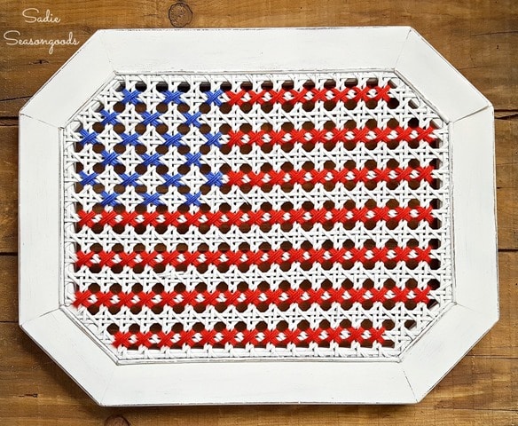 Sadie_Seasongoods_broken_cane_table_repurposed_into_oversized_cross_stitch_American_flag_USA