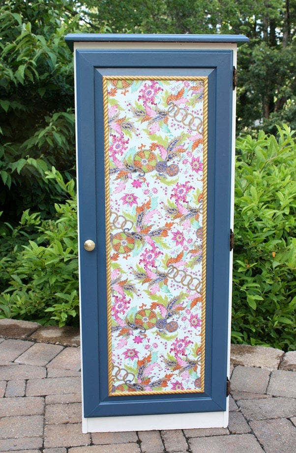 A Sauder cabinet gets a makeover with paint rope trim, and decoupaged gift wrap. Get the details at virginiasweetpea.com