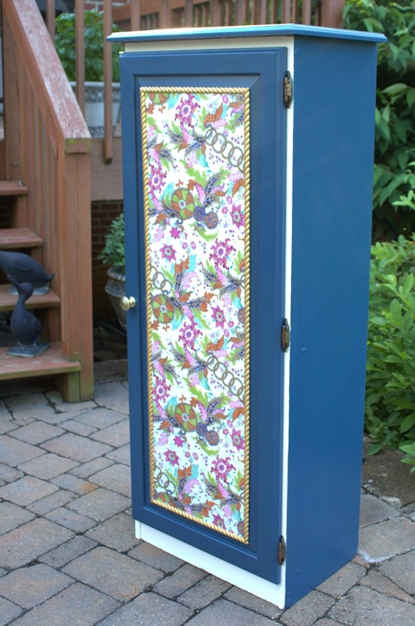 A Sauder cabinet gets a makeover with paint rope trim, and decoupaged gift wrap. Get the details at virginiasweetpea.com