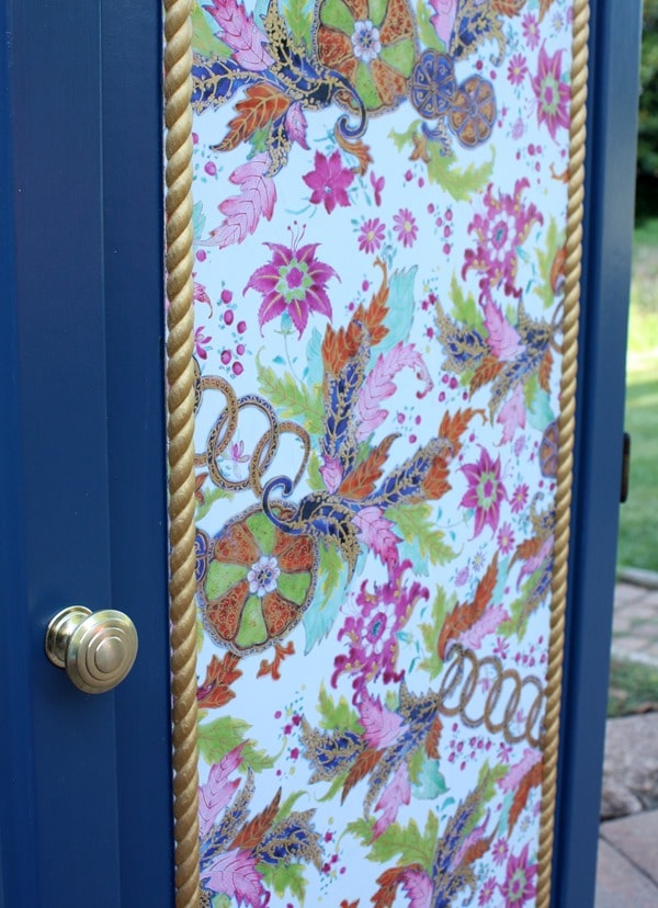 A Sauder cabinet gets a makeover with paint rope trim, and decoupaged gift wrap. Get the details at virginiasweetpea.com.