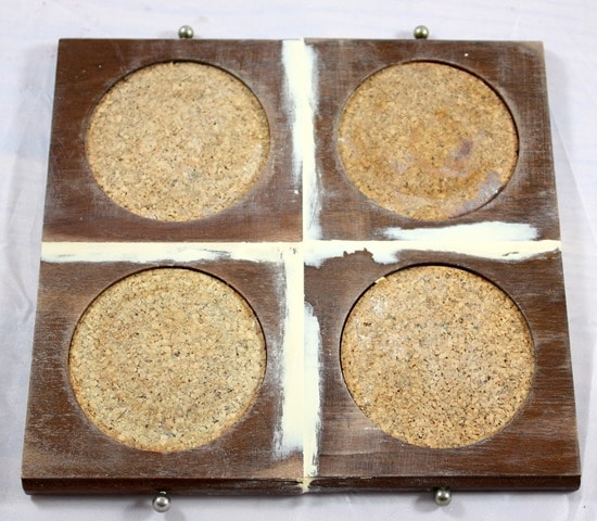 Goodwill coasters are glued together to make a trivet for hot dishes.