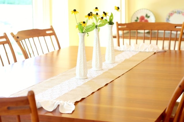 A burlap and lace table runner embelled with a ruffle at either end is an easy 30 minute project that can be enjoyed in any season. Get the tutorial at virginiasweetpea.com.