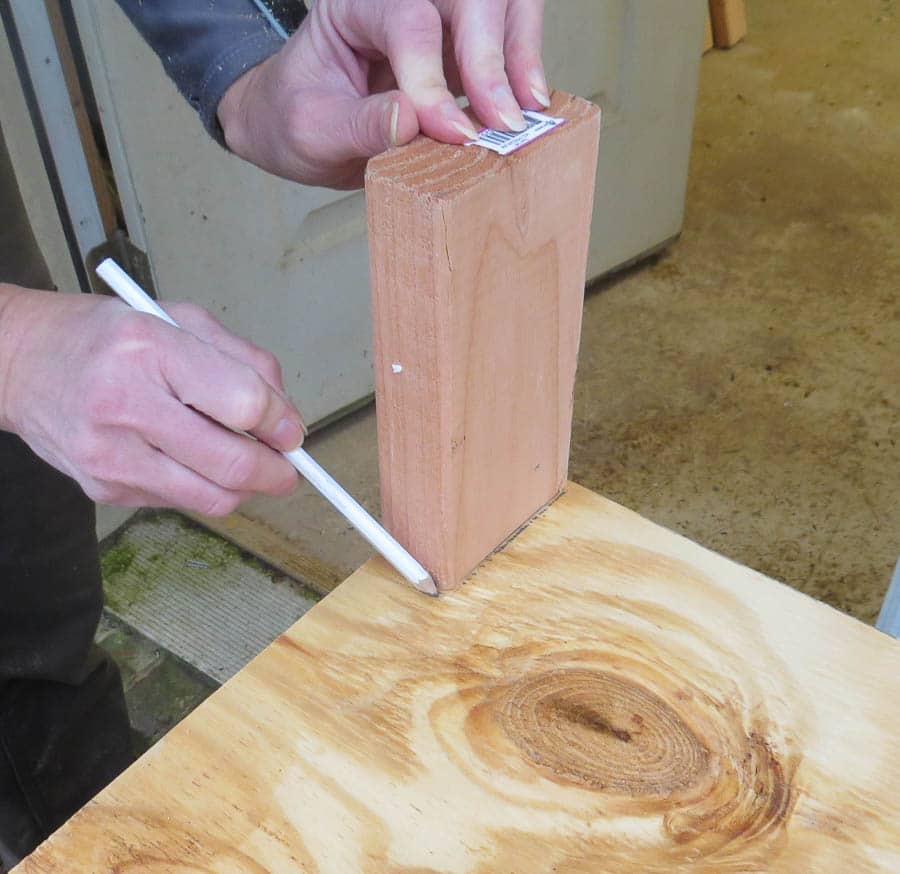 Marking corner to cut to make a 2x4 shelf