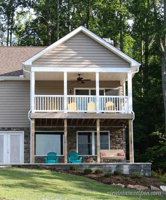 Back of our house at Smith Mountain Lake showing our DIY Adirondack Chairs and our DIY 2x4 Porch Swing