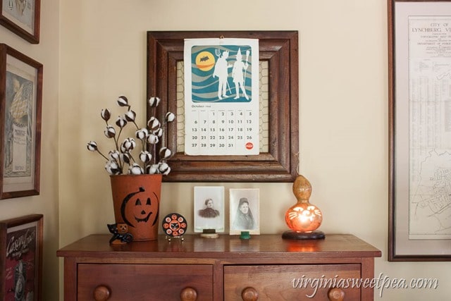 Vintage Inspired Halloween Decor - Vintage toys, old photos, a gourd lamp, and a 1968 Coca-Cola calendar make a fun Halloween vignette. virginiasweetpea.com