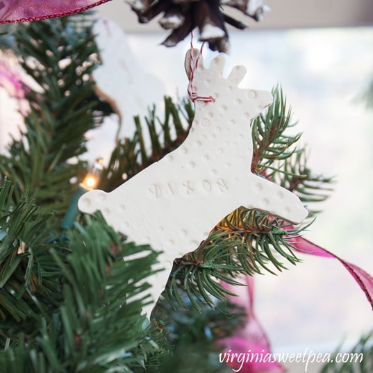 Christmas ornament made from clay in the shape of a reindeer with Vixon stamped on it.