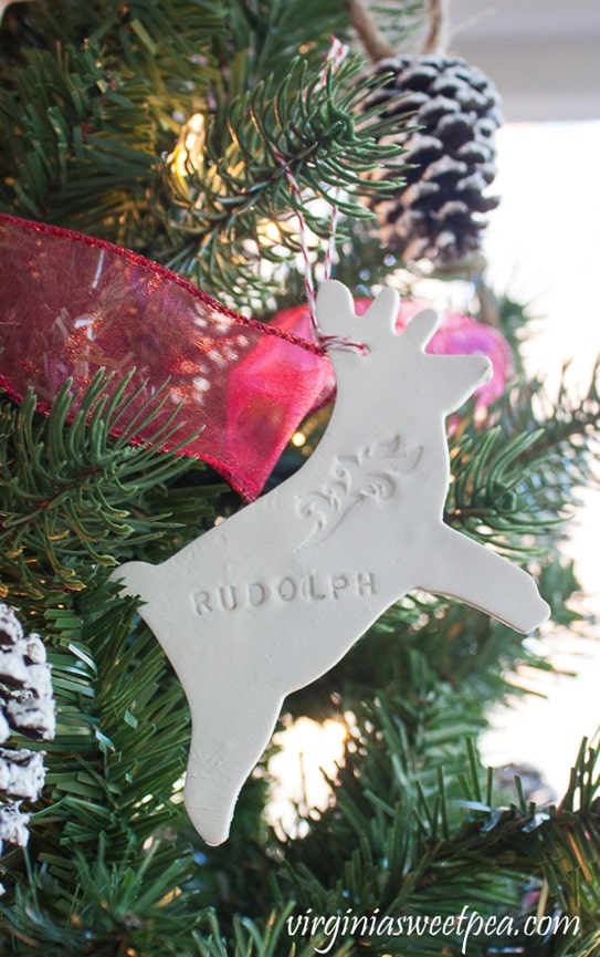 Clay ornament in the shape of a reindeer with Rudolph stamped on it.