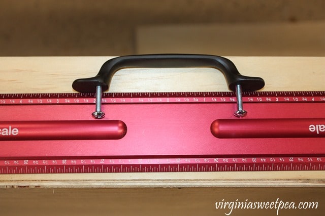 Using a center scale ruler to attach a drawer pull