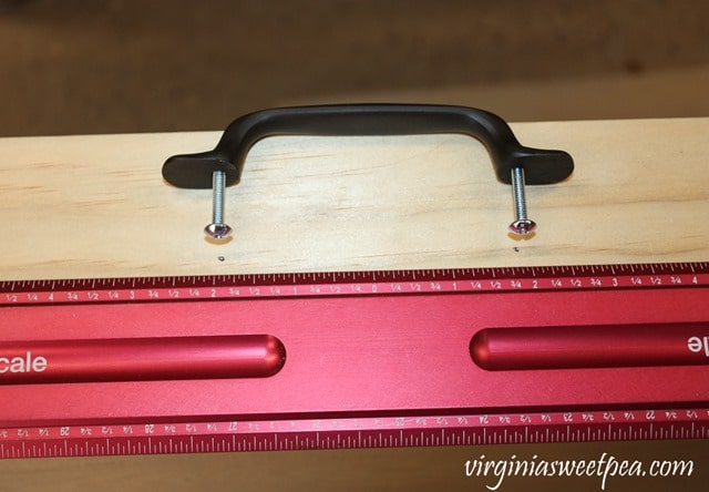 Using a center scale ruler to attach a drawer pull