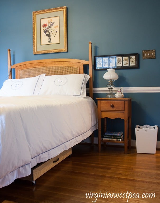 Bedroom with blue walls, antique furniture and a DIYunder bed storage drawer