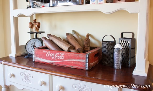 Vintage Coca-Cola crate with an antique scale and small collection of vintage graters. virginiasweetpea.com