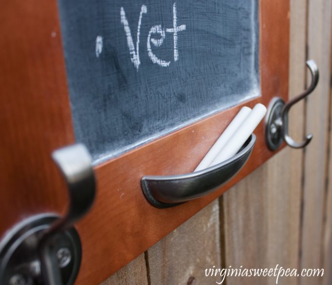 A cabinet door cup pull makes a great chalk holder for a DIY message board and organizer. 