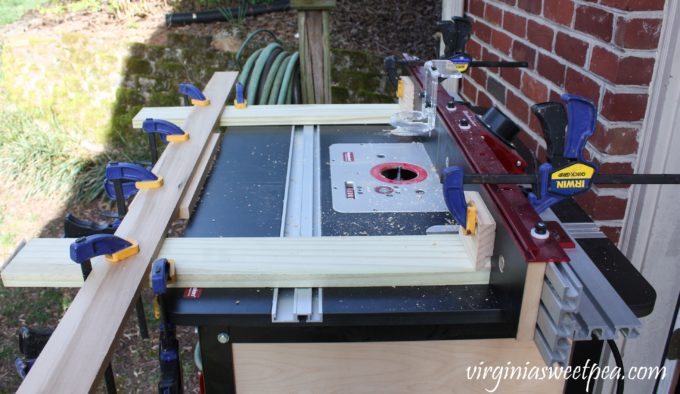 Jig on Router Table with Keyhole Bit to Make Keyholes on a Cabinet Door Used to Make a Message Center