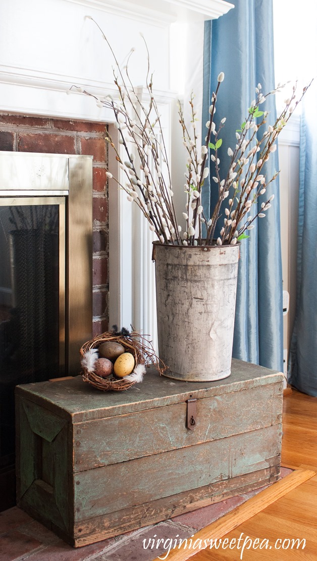 Spring vignette with a vintage tool chest, pussy willow filled sap bucket, and a nest. #spring #springdecor #vintage #vintagedecor