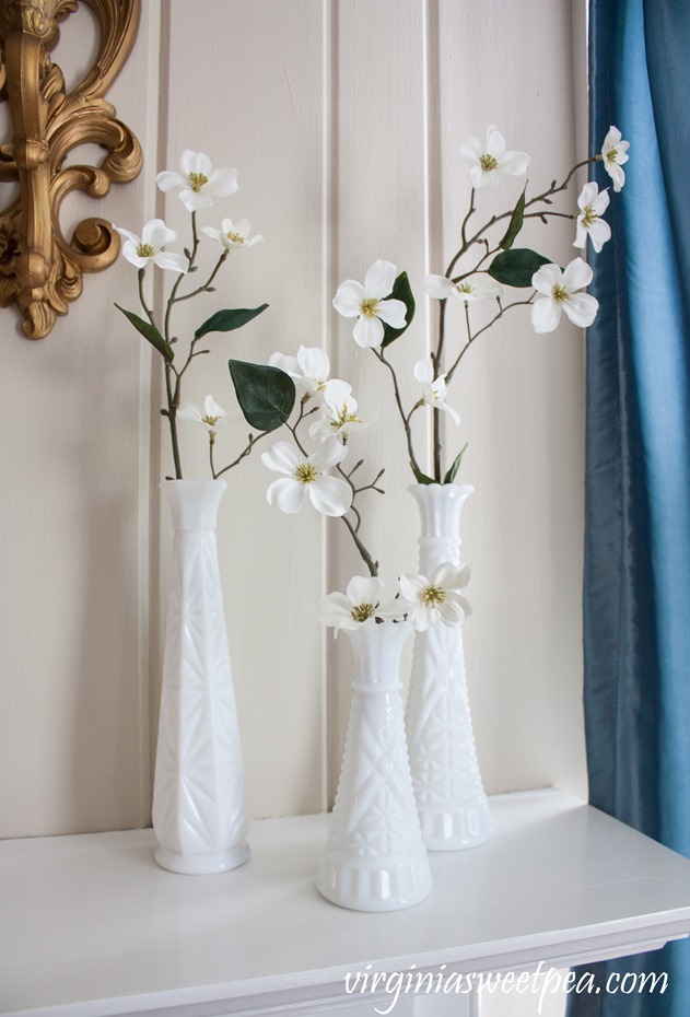 Vintage Milk Glass with spring blooms on a decorated for spring mantel. #spring #springdecor #springmantel #vintage #vintagedecor