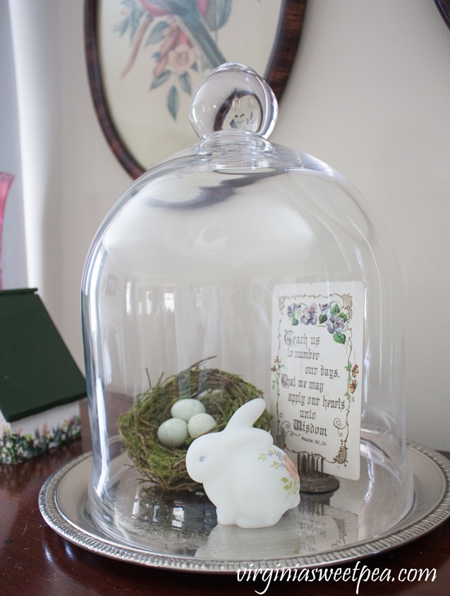 Decorated for spring cloche with a 1911 postcard, nest, and Fenton rabbit. #vintage #vintagedecor #fenton #spring #springdecor