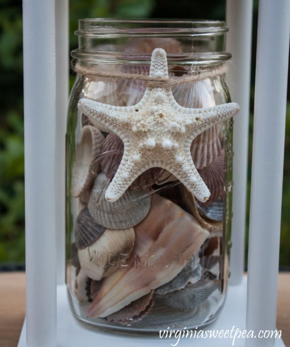 Mason Jar Filled with Shells used for Summer Decor in a DIY Lantern #DIYLantern #masonjar #summerdecor