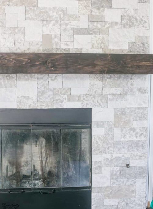 How to Build Your Own Rustic Fireplace Mantel - Learn how to make a rustic fireplace mantel for your home. #diymantel #diyrusticmantel #woodworking