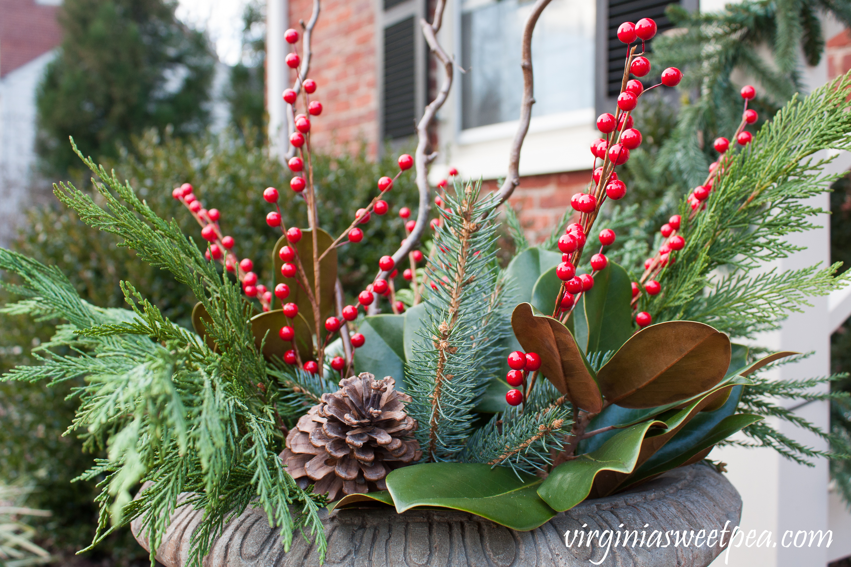 Christmas Front Porch and Holiday Door Decor - Urns filled with greenery, berries, and curly willow for Christmas. #christmas #christmasurns #christmasdoors #christmasoutdoors #christmasdecor