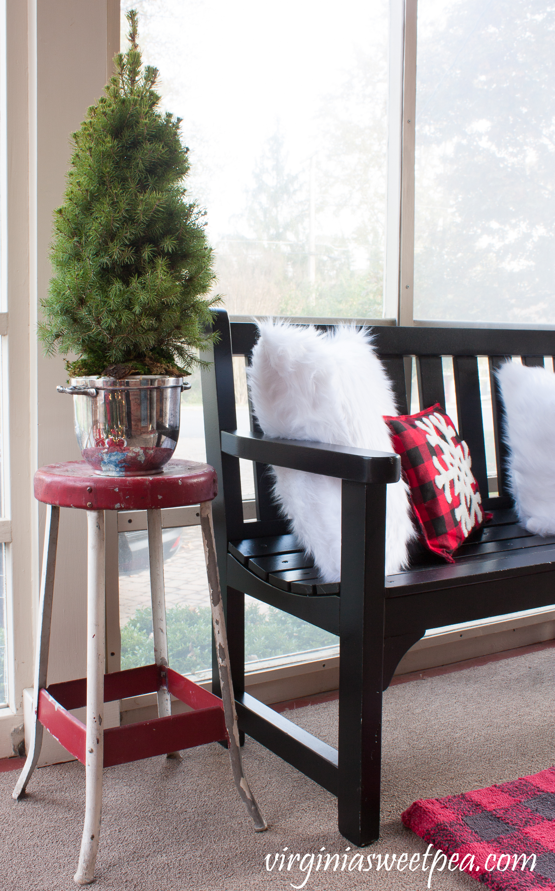 Christmas Porch Decor - A vintage metal stool is topped with a tree planted in a vintage silver ice bucket. #christmas #christmasdecorations #christmasporch #vintage #vintagechristmas