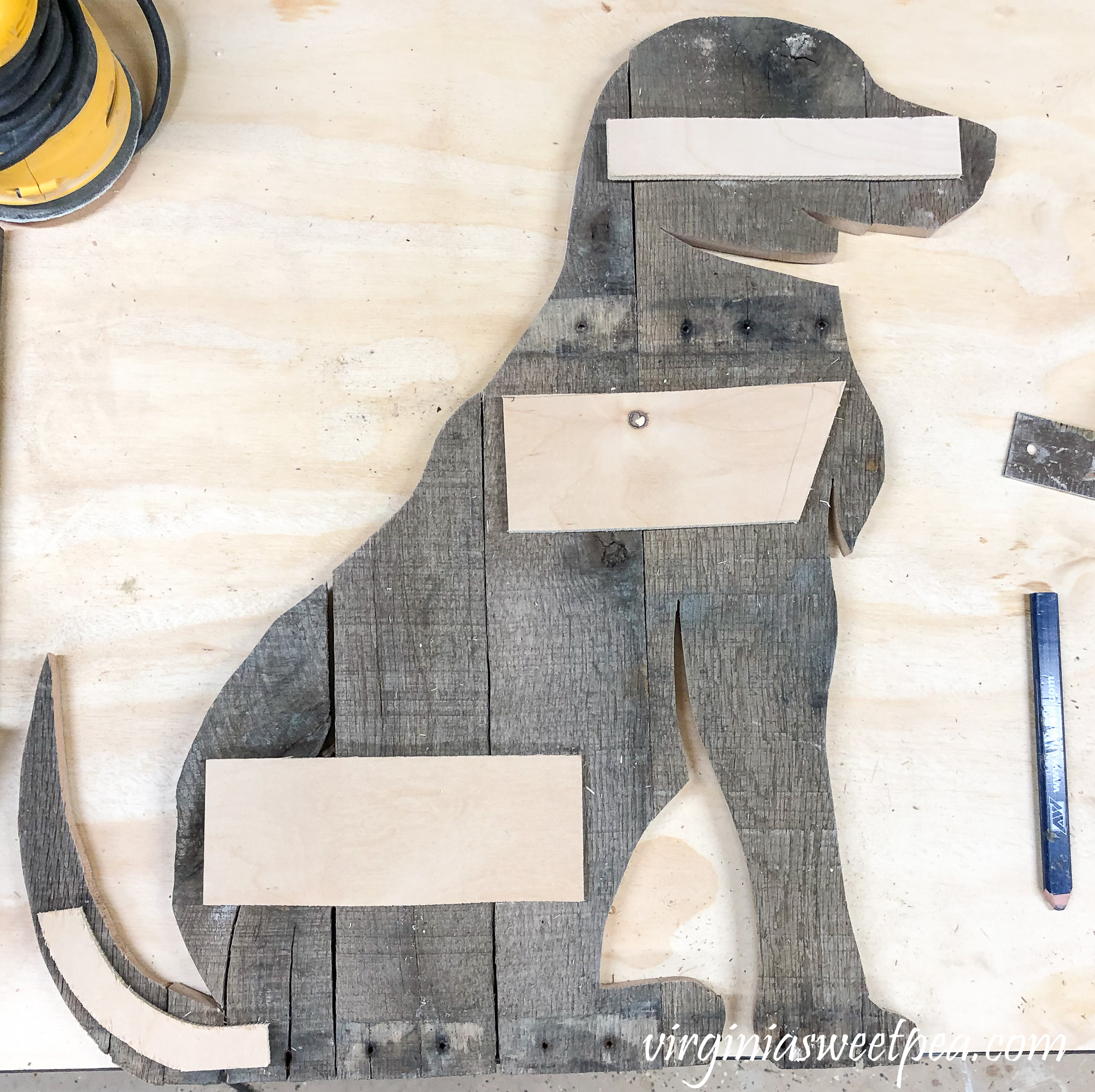 How to Make a Pallet Wood Dog - Pallet pieces cut in the shape of a dog connected together.