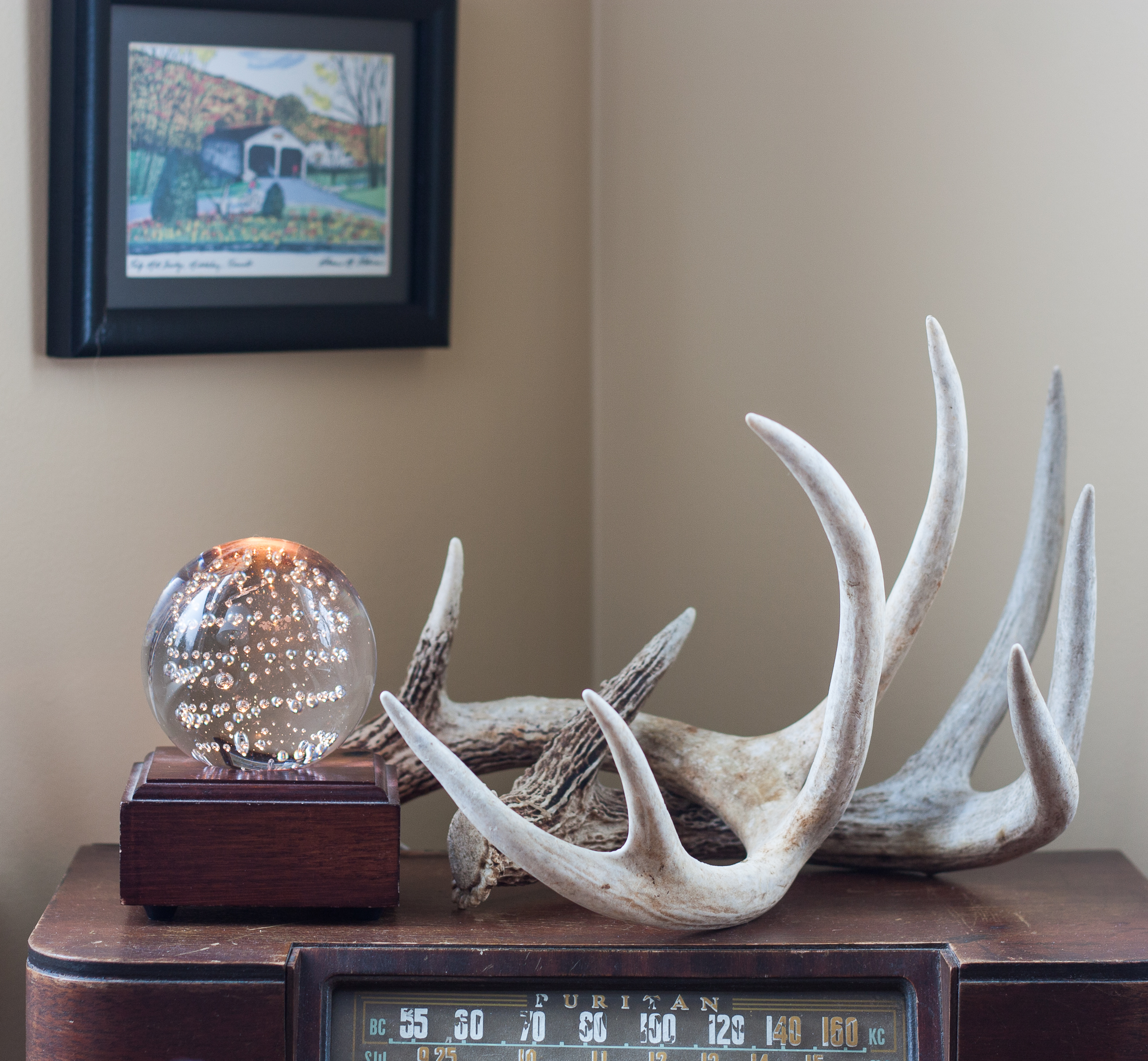 Cozy Winter Decor - Antlers and a lighted glass globe. #cozy #winterdecor #deerantlers