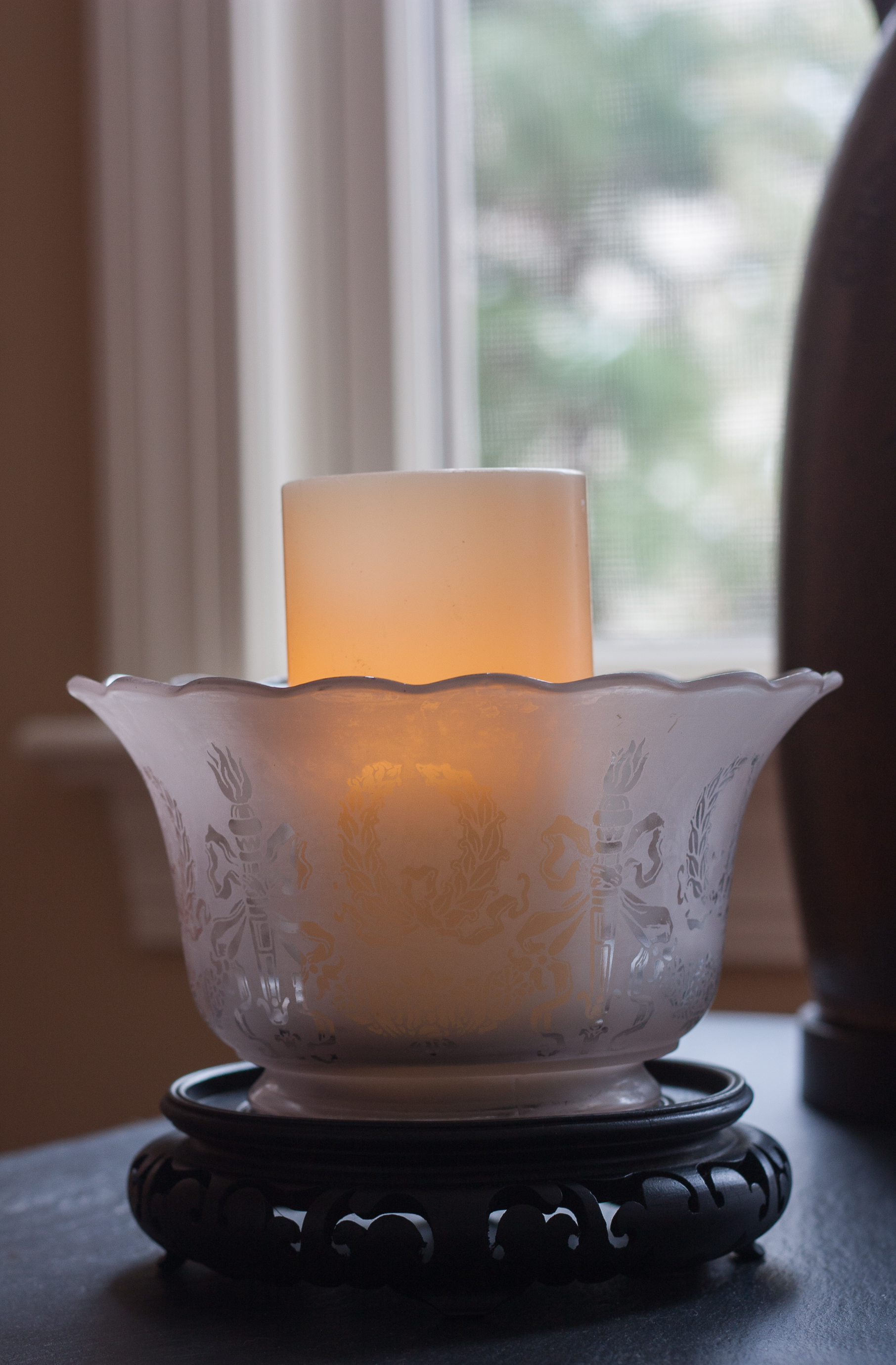 Antique glass light shade used with a candle.