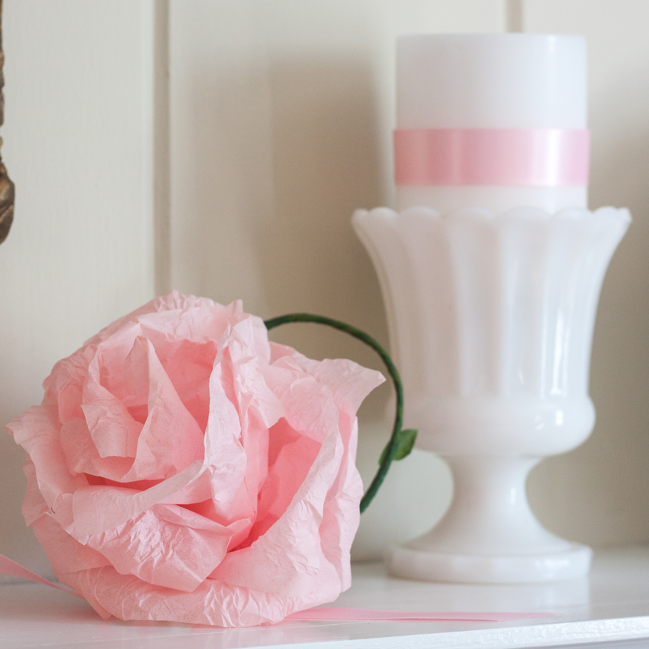 Vintage milk glass and crepe paper flower used on a Valentine's Day romantic mantel. #valentinesday #valentinesdaymantel #valentinesdaydecor #crepepaperflower #paperflower #milkglass