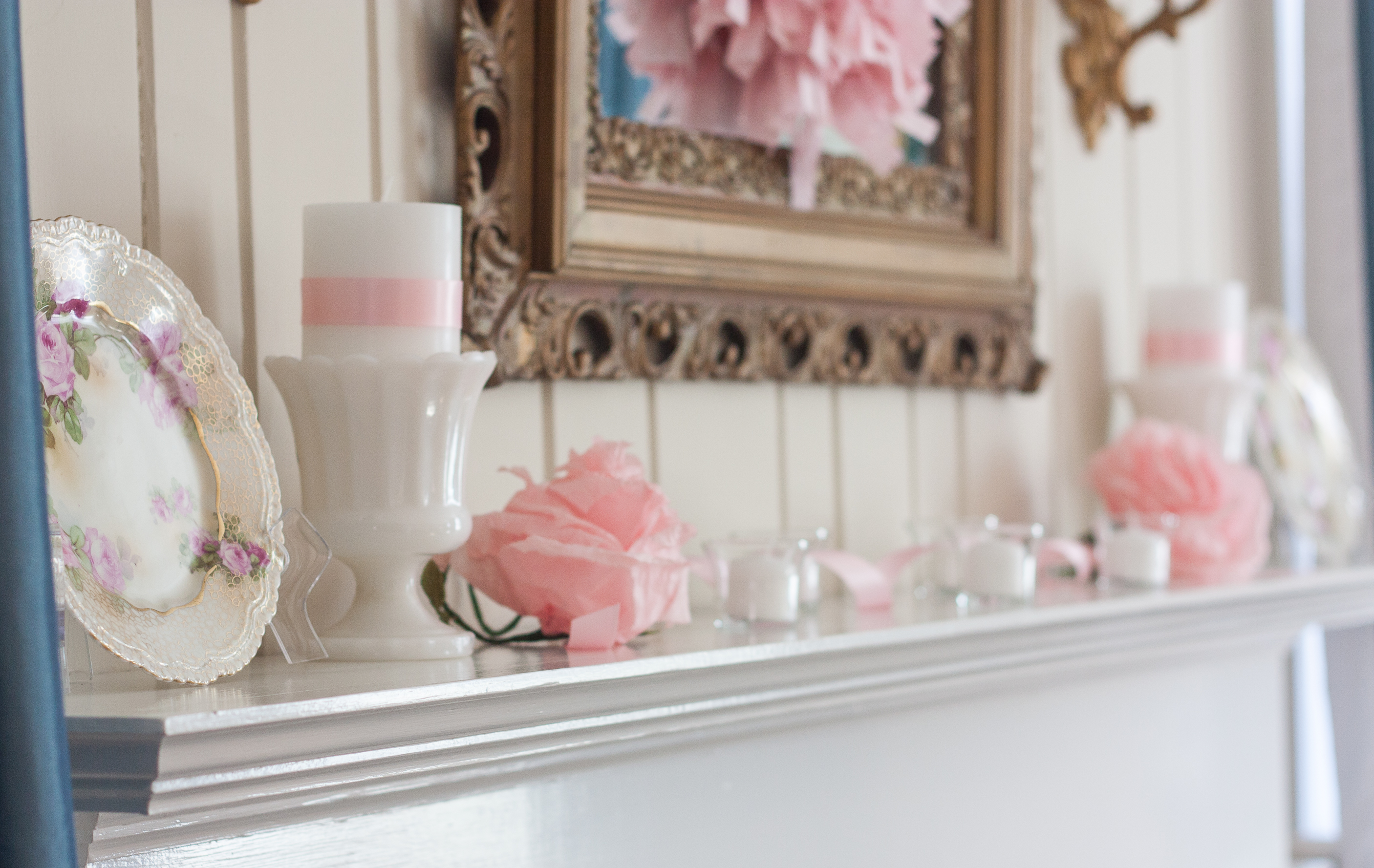 Romantic and Vintage Valentine's Day Mantel - See a mantel decorated with antique floral plates, milk glass, crepe paper flowers, and votives filled with white candles. #valentinesday #valentinesdaydecor #romantic #romanticdecor #vintage #vintagedecor