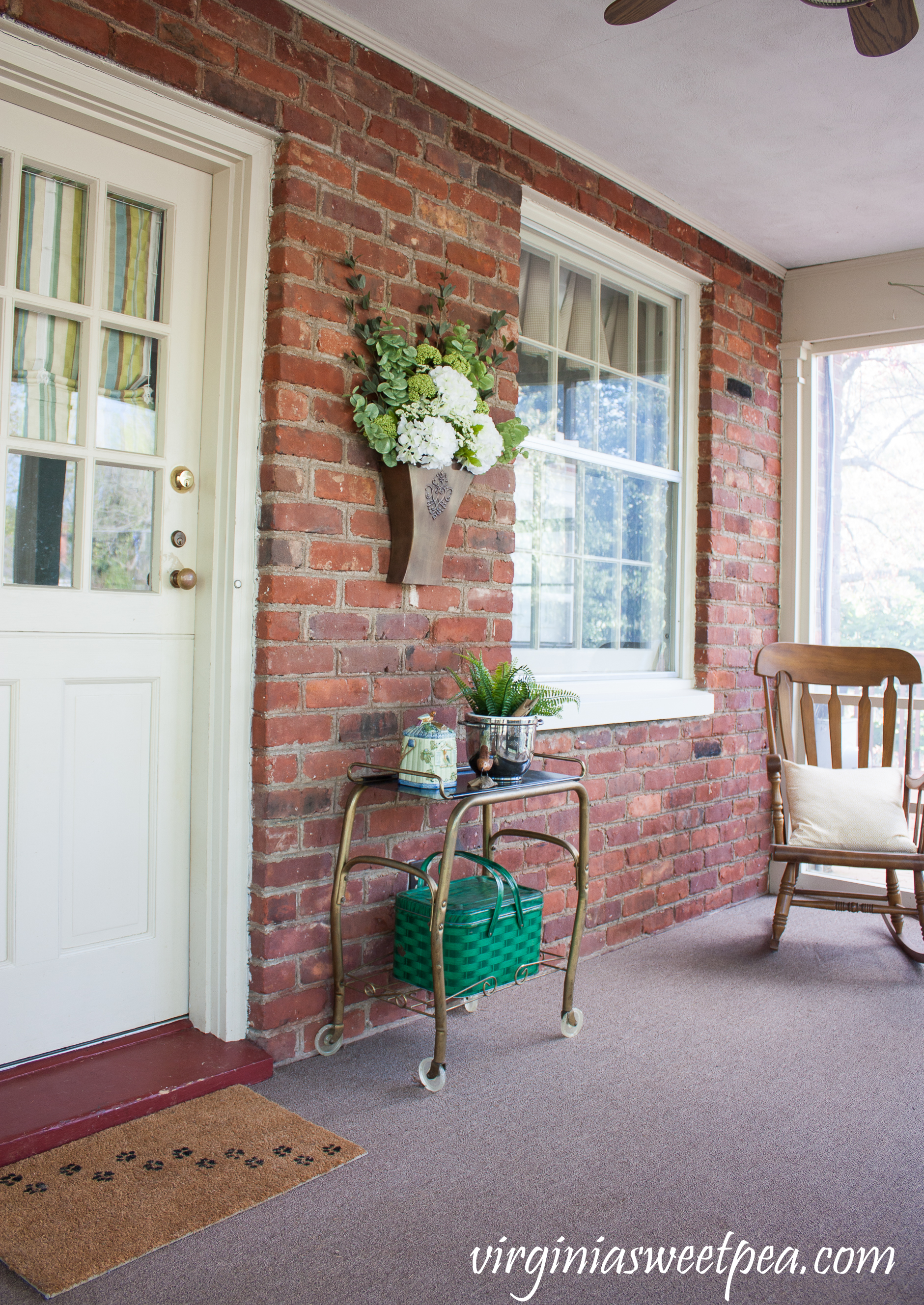 Spring on the porch with a hanging flower arrangement in a Southern Living at Home Willow House Flower Market Door Bucket